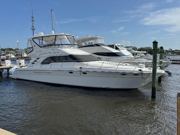 Sea Ray 560 Sedan Bridge 2004 Sea Ray 560 Sedan Bridge yacht docked at marina under clear blue sky.