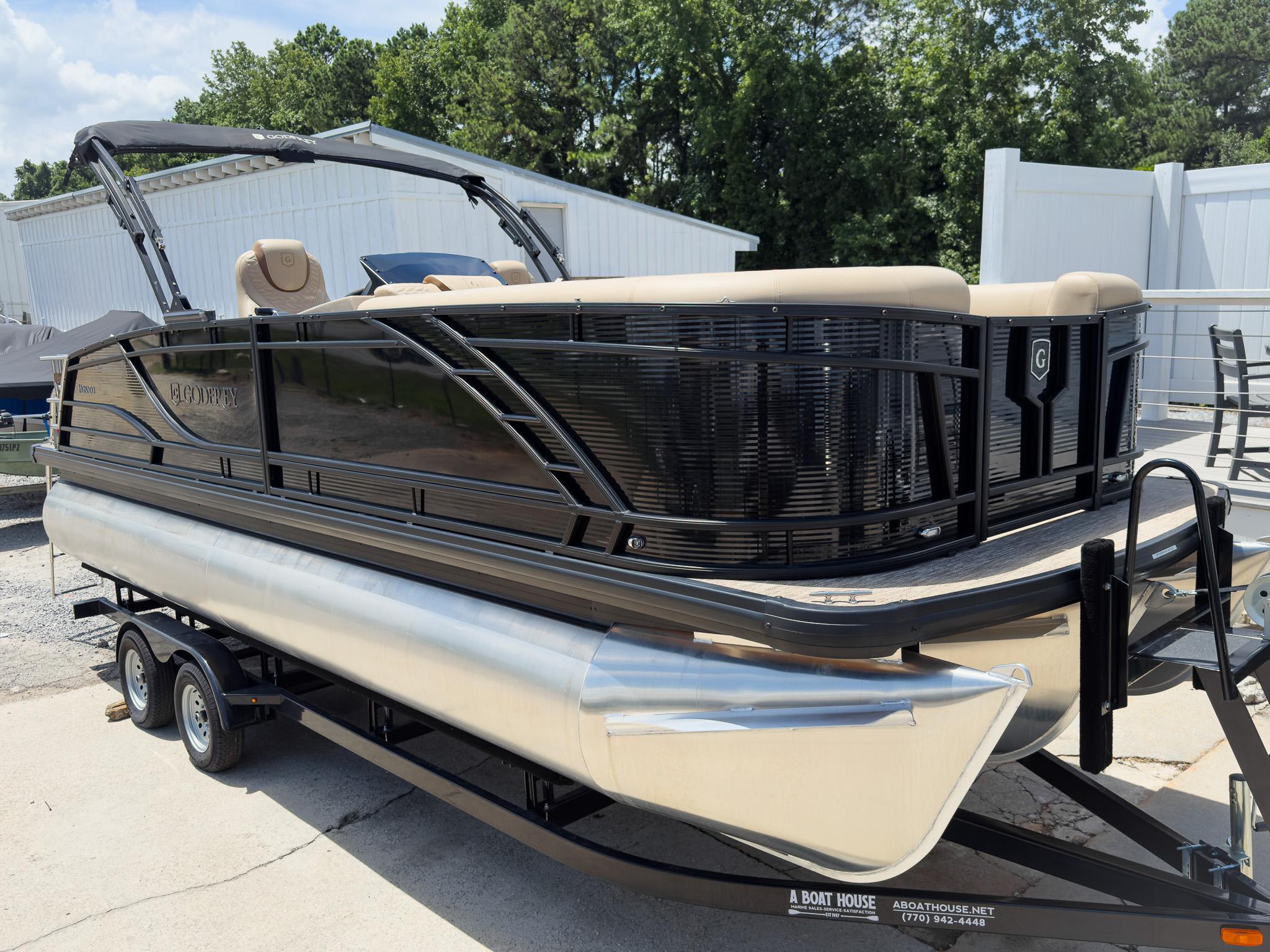 Godfrey Monaco 23' Dual Flip Lounge Tritoon - 235 DFL 2025 Godfrey Monaco 23' Dual Flip Lounge Tritoon on trailer, parked outdoors.
