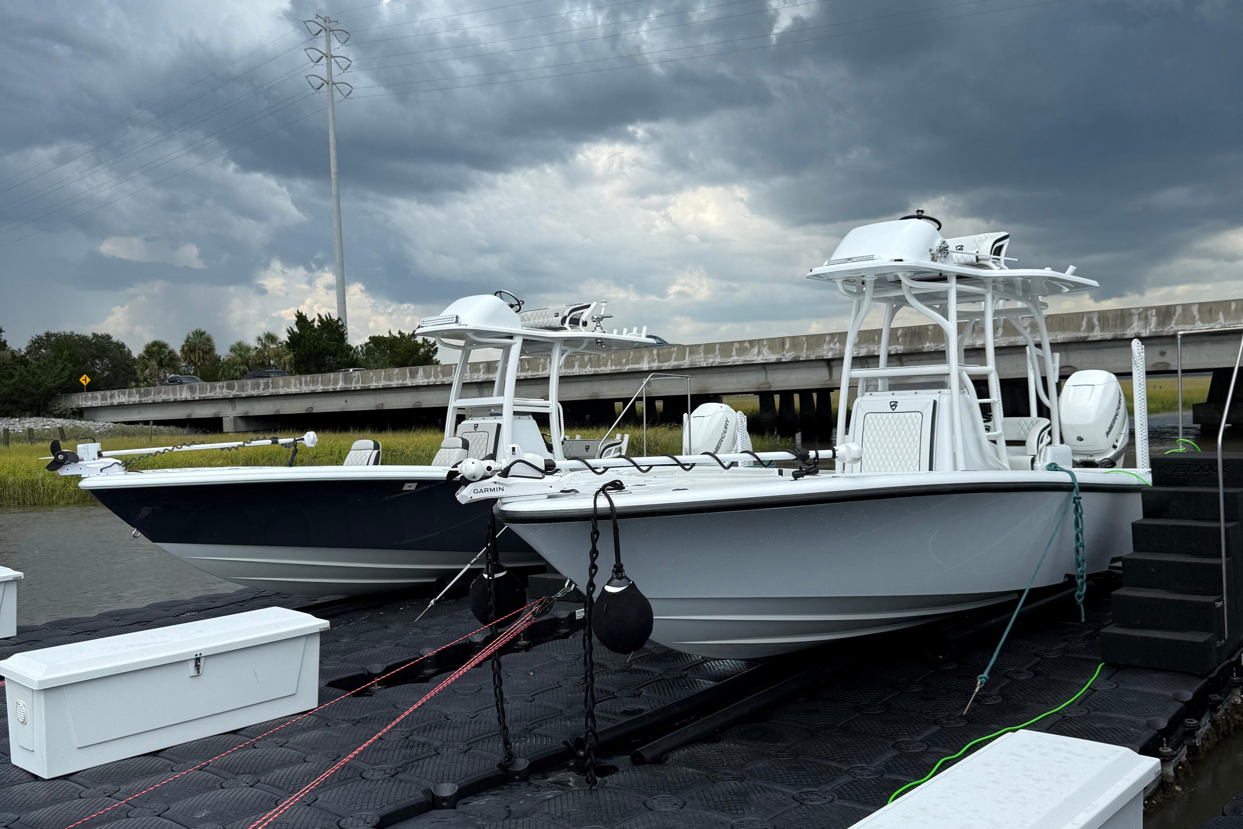Barker Boatworks 26 Open 2019 Barker Boatworks 26 Open boats docked under stormy skies.