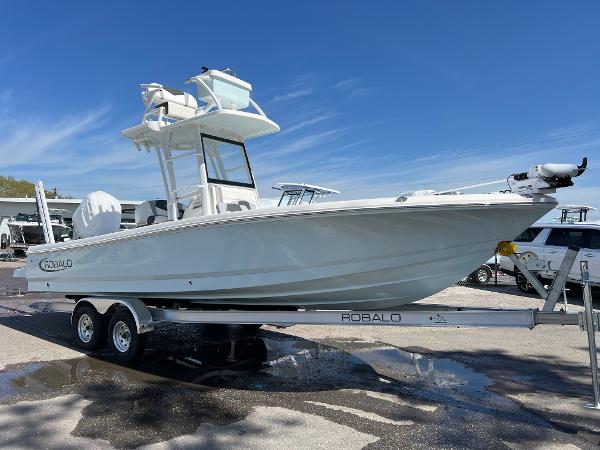 Robalo 246 Sky Deck 2024 Robalo 246 Sky Deck boat on a trailer under a clear blue sky.