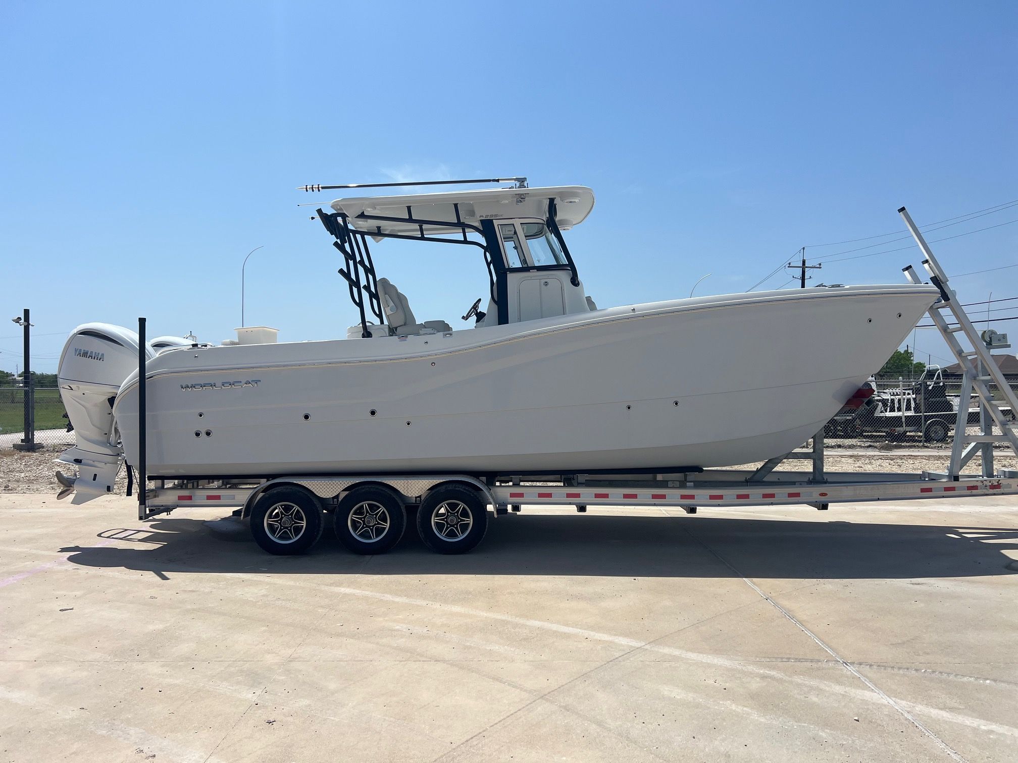 World Cat 295 CC 2024 World Cat 295 CC boat on trailer, side view, clear sky background.
