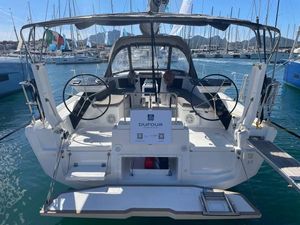 Dufour 37 2023 Dufour 37 yacht at marina, featuring dual steering wheels and spacious cockpit.