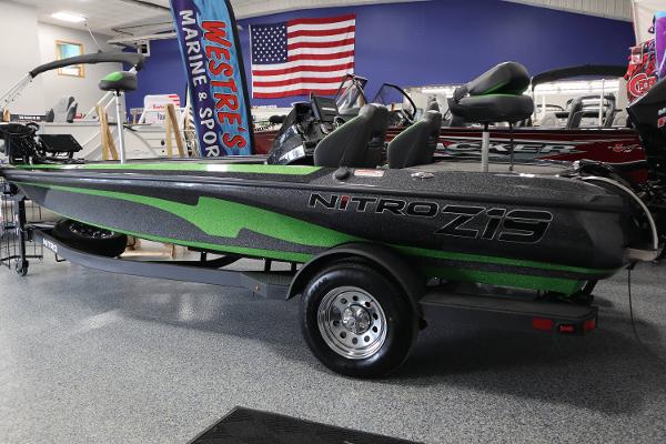 Nitro Z19 2025 Nitro Z19 boat with green accents displayed indoors at a marine sports store.