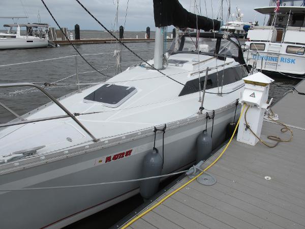 O'Day 322 1987 O'Day 322 sailboat docked at marina with fenders and power hookup.