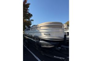 Ranger Reata 223FC 2024 Ranger Reata 223FC pontoon boat on trailer, parked outdoors under clear sky.