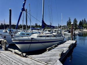 LM 30 1984 LM 30 sailboat docked at a marina under clear blue skies.