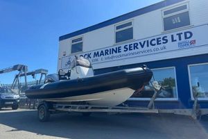 Zodiac Open 5.5 Zodiac Open 5.5 boat on trailer outside Rock Marine Services building.