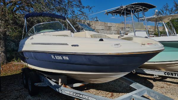 Sea Ray 200 Sundeck 2005 Sea Ray 200 Sundeck boat on trailer, parked outdoors under clear blue sky.