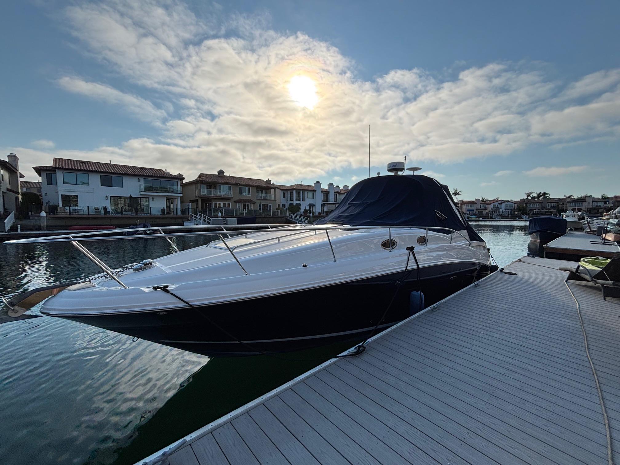 Sea Ray 320 Sundancer 2006 Sea Ray 320 Sundancer docked at marina under a cloudy sky.