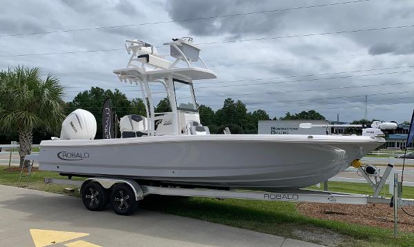 Robalo 246 Cayman SD 2024 Robalo 246 Cayman Sky Deck boat on a trailer, side view.