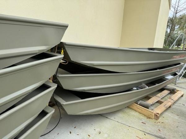 Tracker Grizzly 1436 Utility Stacked 2025 Tracker Grizzly 1436 Utility boats on pallets outside.