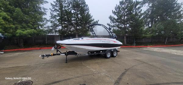 Tahoe 1950 Tahoe 1950 boat 2023 model on trailer in parking lot with trees in background.