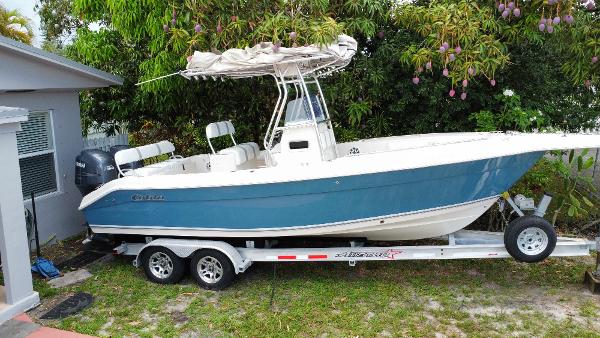 Cobia 256 CC 2008 Cobia 256 CC boat on trailer, parked beside a house.