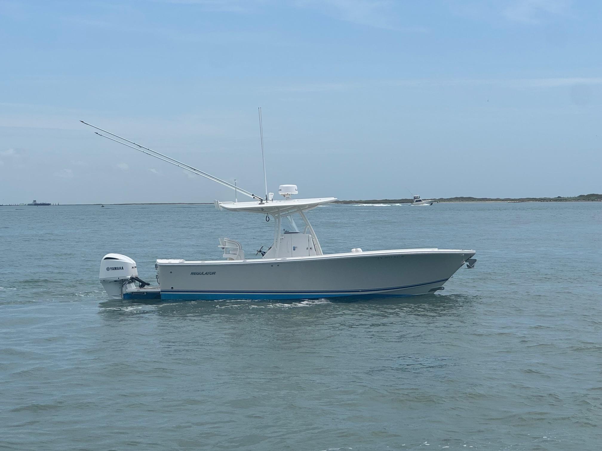 Regulator Center Console 2016 Regulator Center Console boat on calm water with Yamaha engine.
