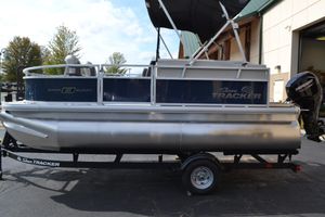 Sun Tracker Bass Buggy 16 XL Select 2026 Sun Tracker Bass Buggy 16 XL Select pontoon boat on trailer, outdoor setting.