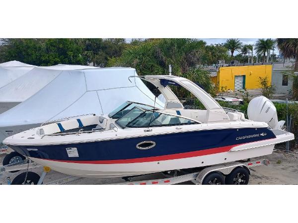 Chaparral 270 OSX 2024 Chaparral 270 OSX boat with sleek design, docked outdoors.
