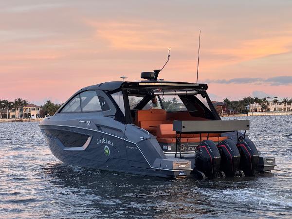 Cruisers Yachts 42 GLS OB 2021 Cruisers Yachts 42 GLS OB on water at sunset, featuring triple outboard engines.