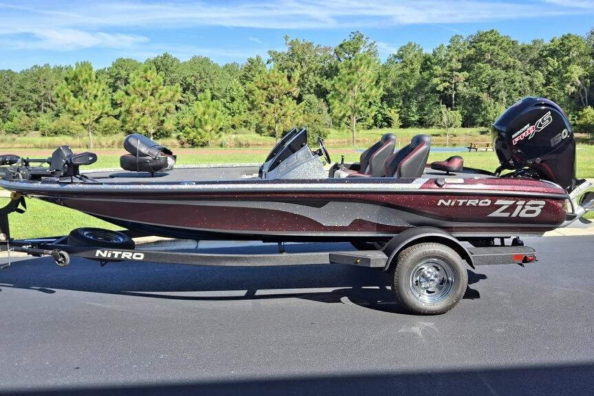 Nitro Z18 Pro 2026 Nitro Z18 Pro bass boat on trailer, parked outdoors with trees in background.