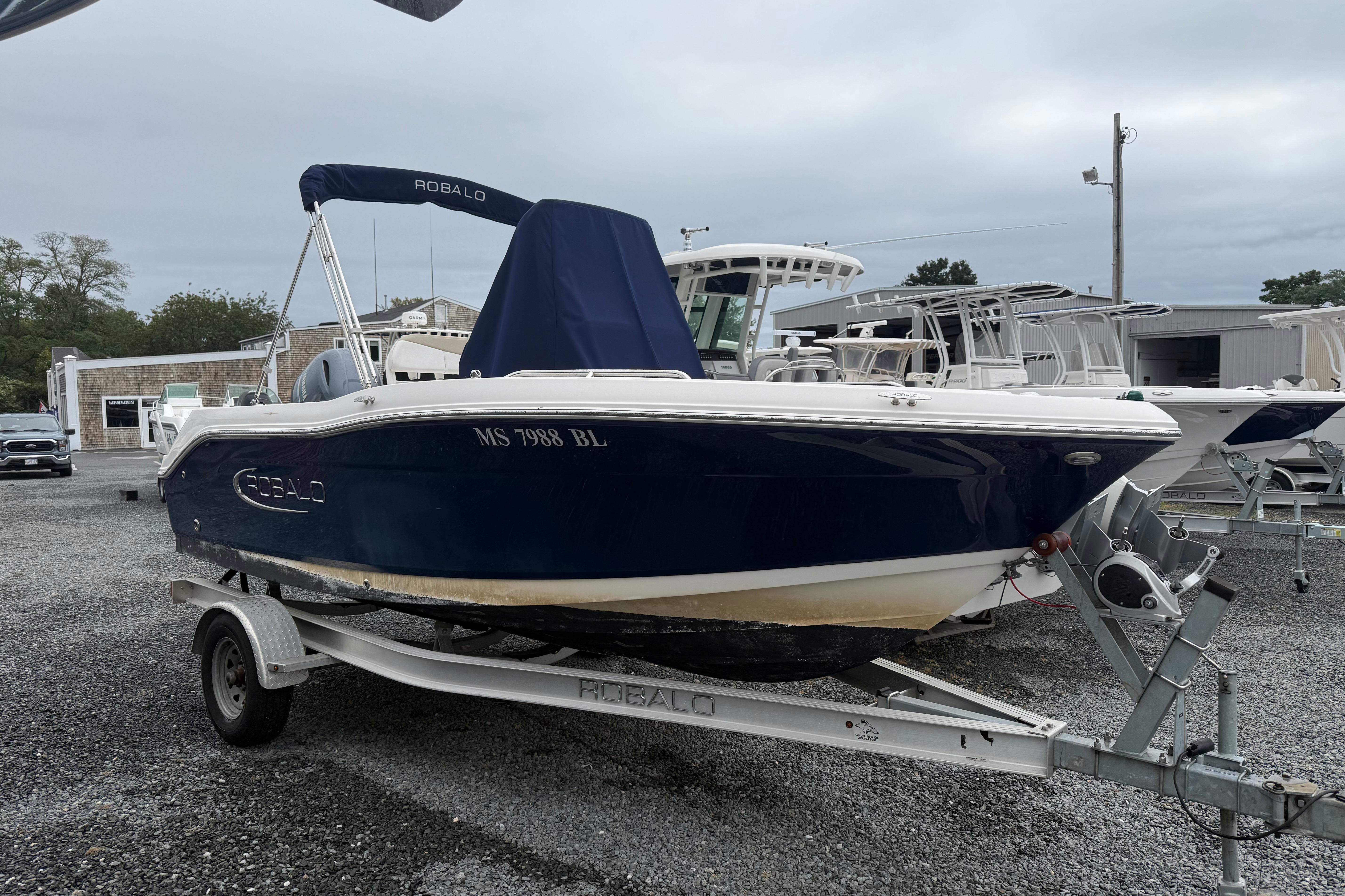 Robalo R180 Center Console 2019 Robalo R180 Center Console boat on trailer, parked outdoors.