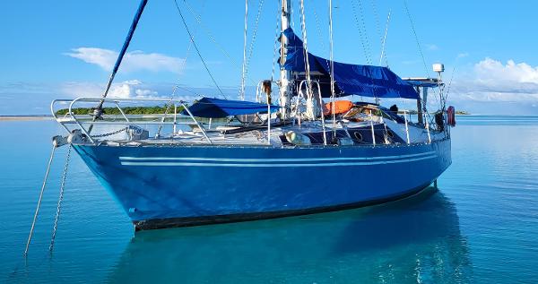 ACM Trisbal 36 Blue ACM Trisbal 36 sailboat from 1980 on calm turquoise water.