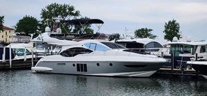 Azimut 45 Flybridge 2013 Azimut 45 Flybridge yacht docked at marina, sleek design, calm water, overcast sky.
