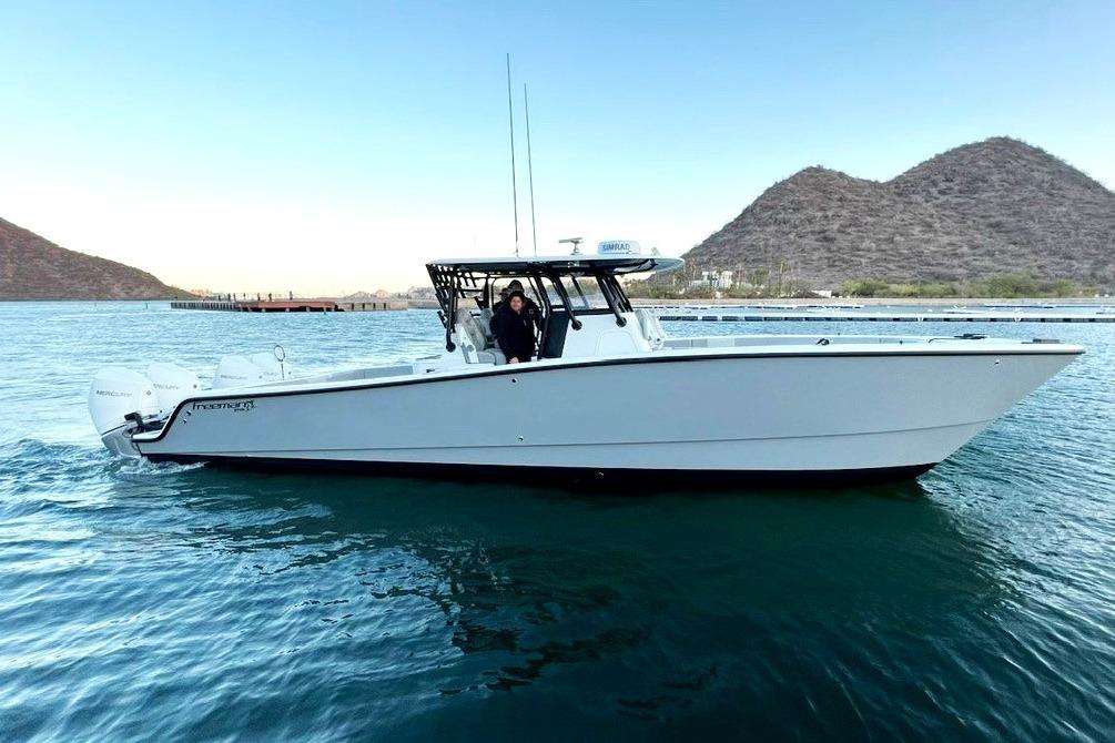 Freeman 37 Center Console 2022 Freeman 37 Center Console boat on water with scenic mountain backdrop.