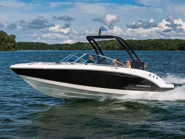 Chaparral 23 SSi 2025 Chaparral 23 SSi boat cruising on a lake under a partly cloudy sky.