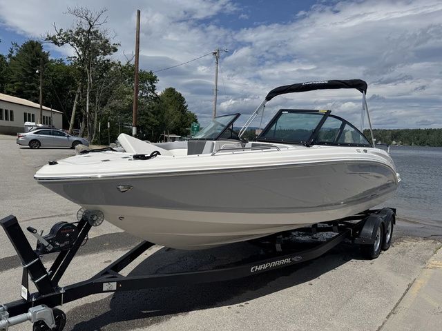 Chaparral 23 SSi 2025 Chaparral 23 SSi boat on trailer by lakeside, under cloudy sky.