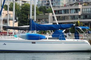 Catalina 320 1996 Catalina 320 sailboat docked in marina, surrounded by modern buildings.