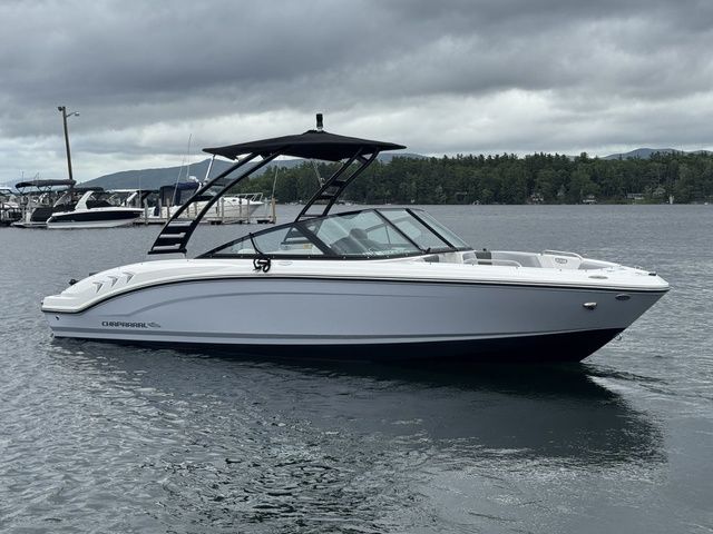Chaparral 21 SSi 2025 Chaparral 21 SSi boat on a calm lake under cloudy skies.