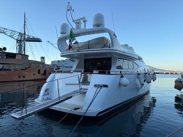 Maiora 20 Luxurious 1998 Maiora 20 yacht docked, featuring sleek design and Italian flag.