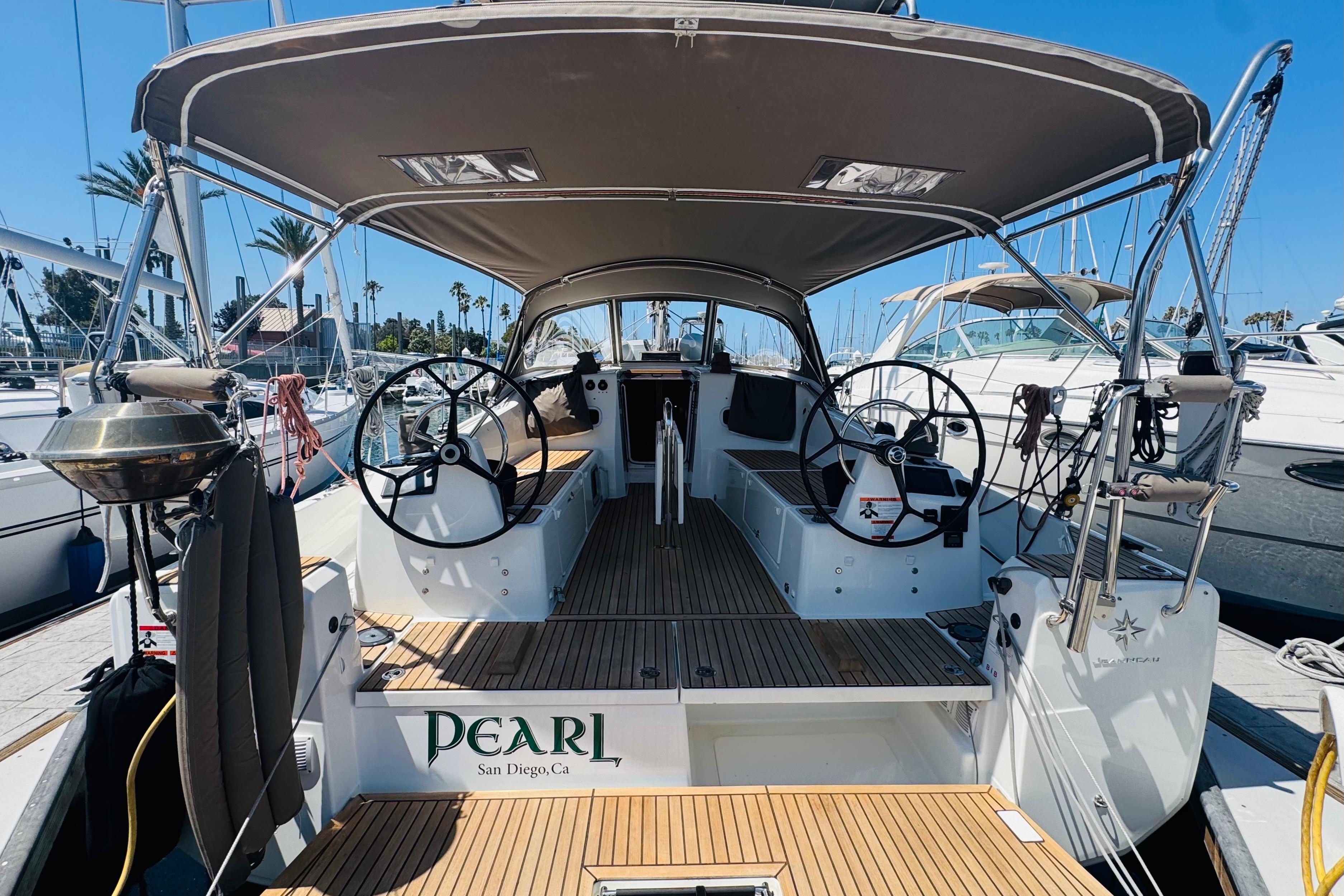 Jeanneau 380 2023 Jeanneau 380 sailboat docked in San Diego marina, featuring dual steering wheels.