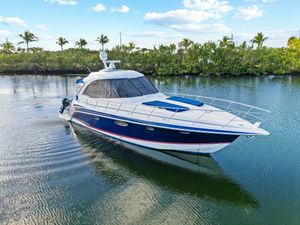 Formula 45 Yacht 2007 Formula 45 Yacht cruising on a serene waterway with lush greenery and palm trees.