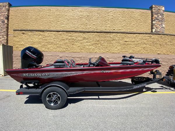 Ranger RT178 2024 Ranger RT178 boat in red, parked on a trailer, side view.