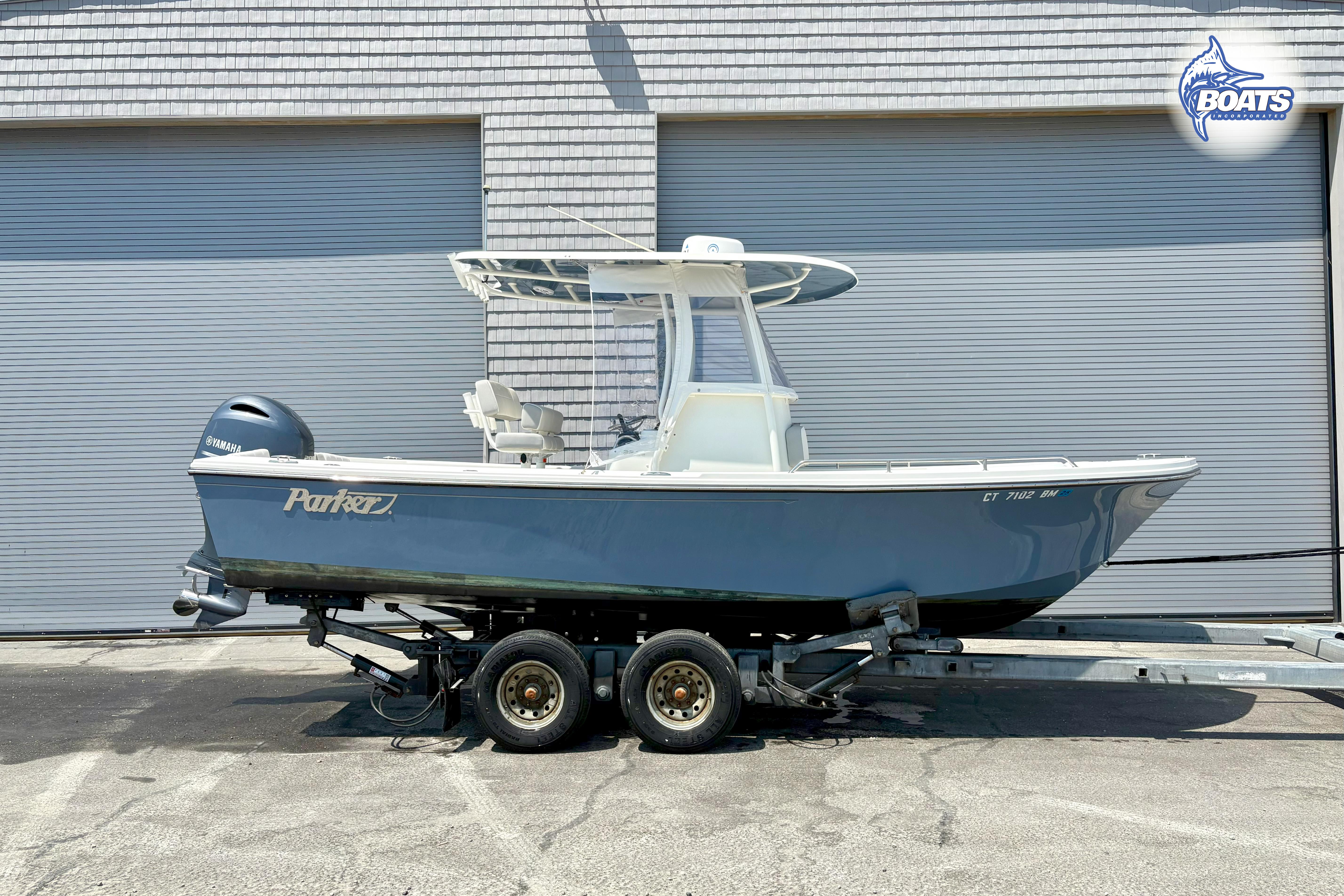 Parker 2300 Center Console 2021 Parker 2300 Center Console boat on trailer, parked in front of a garage.