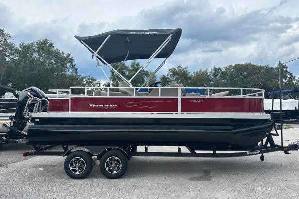 Ranger Reata 200F 2024 Ranger Reata 200F pontoon boat with canopy on trailer, parked outdoors.