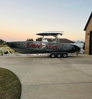 Cape Horn 36 XS 2024 Cape Horn 36 XS boat on trailer, parked in driveway at sunset.