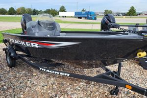 Tracker Super Guide V-16 SC 2026 Tracker Super Guide V-16 SC boat on trailer, parked on gravel.