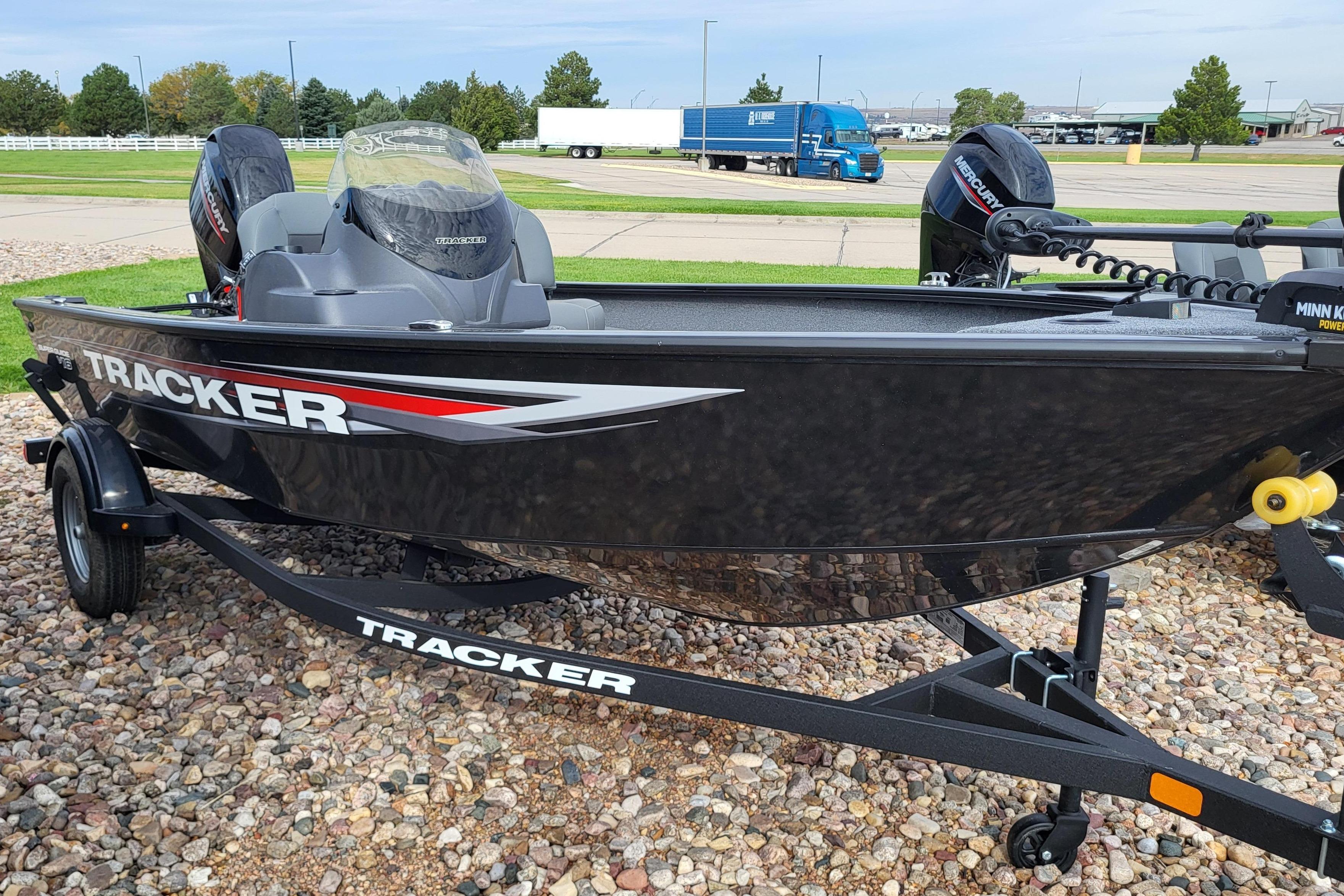 Tracker Super Guide V-16 SC 2026 Tracker Super Guide V-16 SC boat on trailer, parked on gravel.