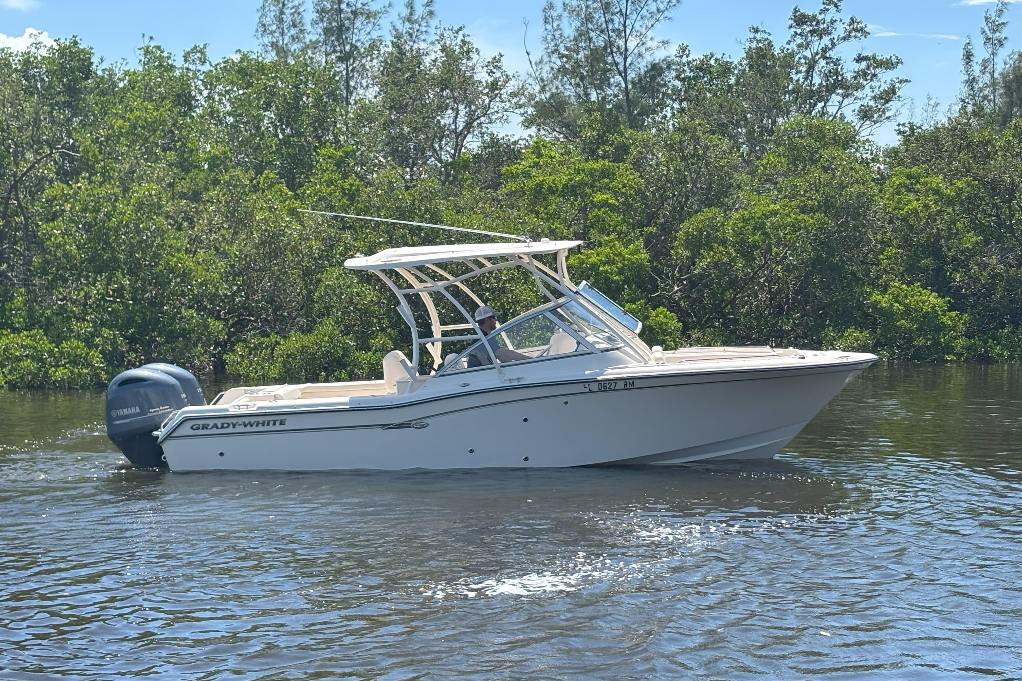Grady-White Freedom 255 2018 Grady-White Freedom 255 boat cruising on a calm river with lush greenery.