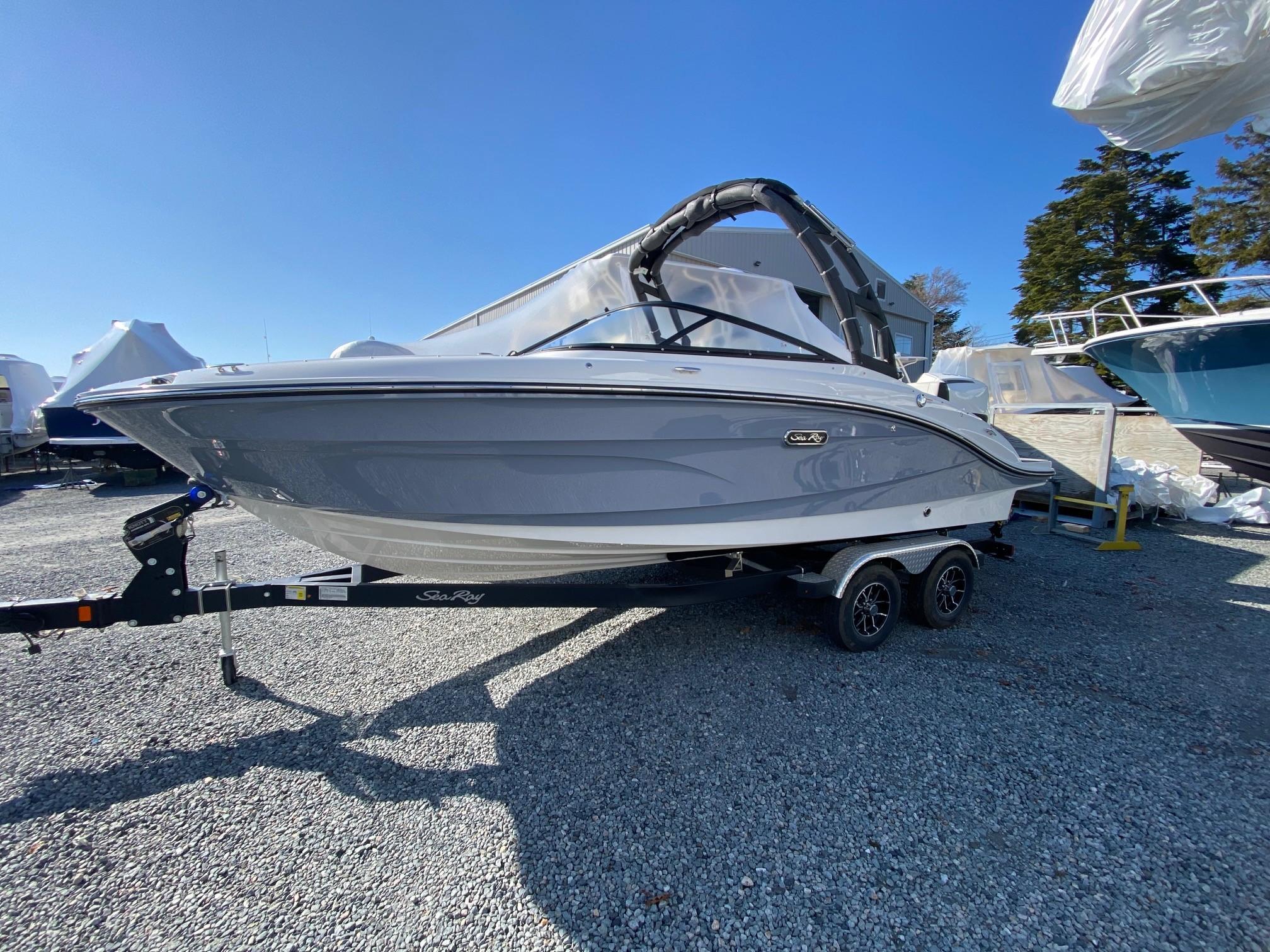 Sea Ray SPX 210 Outboard 2025 Sea Ray SPX 210 Outboard boat on trailer, parked outdoors under clear blue sky.