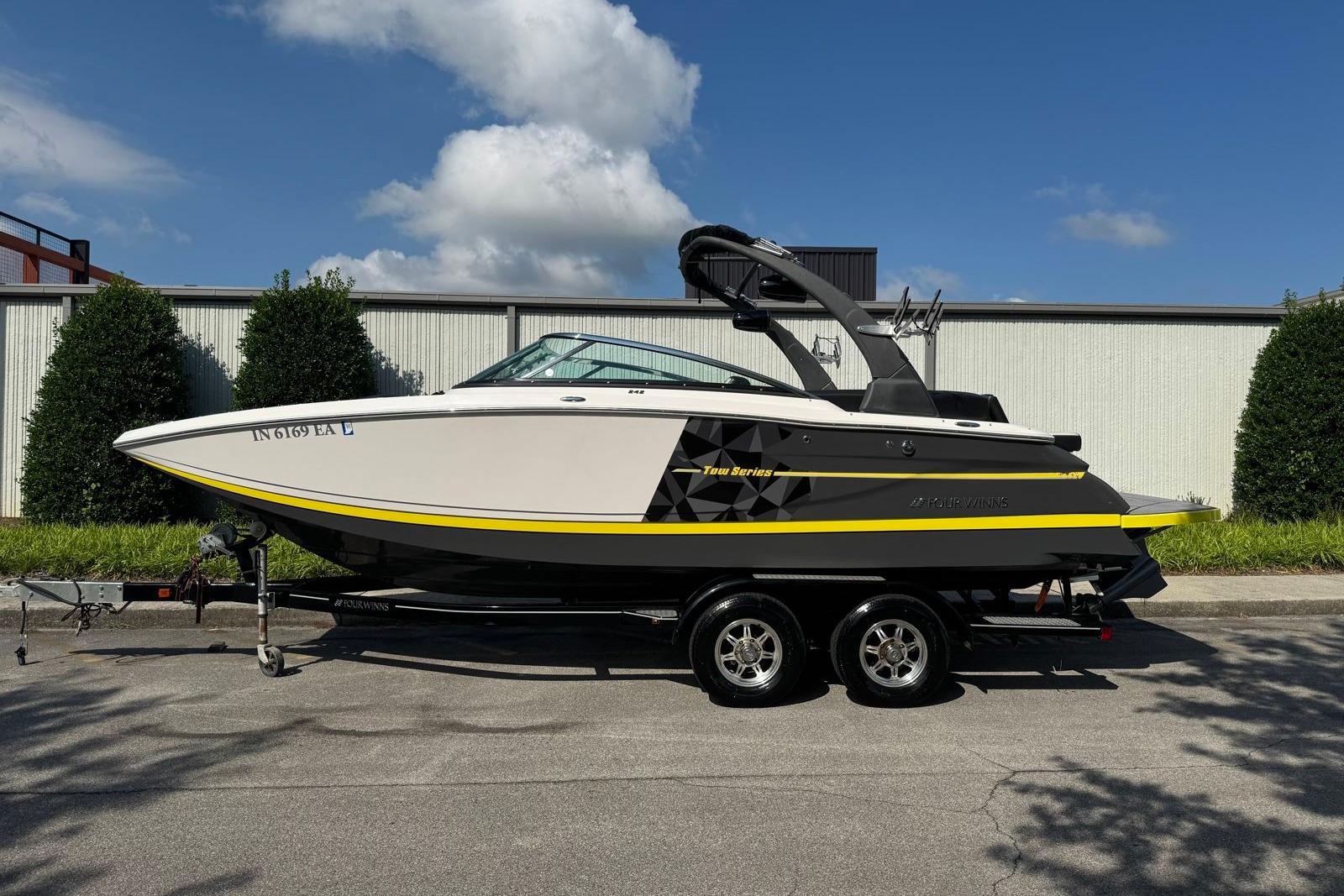 Four Winns TS242 2017 Four Winns TS242 boat on trailer, parked outdoors under blue sky.