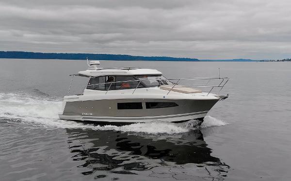 Jeanneau NC9 2016 Jeanneau NC9 cruising on calm waters under cloudy skies.