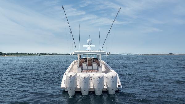 Everglades 455cc 2023 Everglades 455cc boat on open water, rear view with multiple engines.