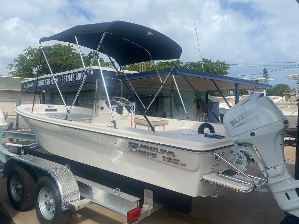 Carolina Skiff 162 JLS 2023 Carolina Skiff 162 JLS boat on trailer with Suzuki outboard motor.