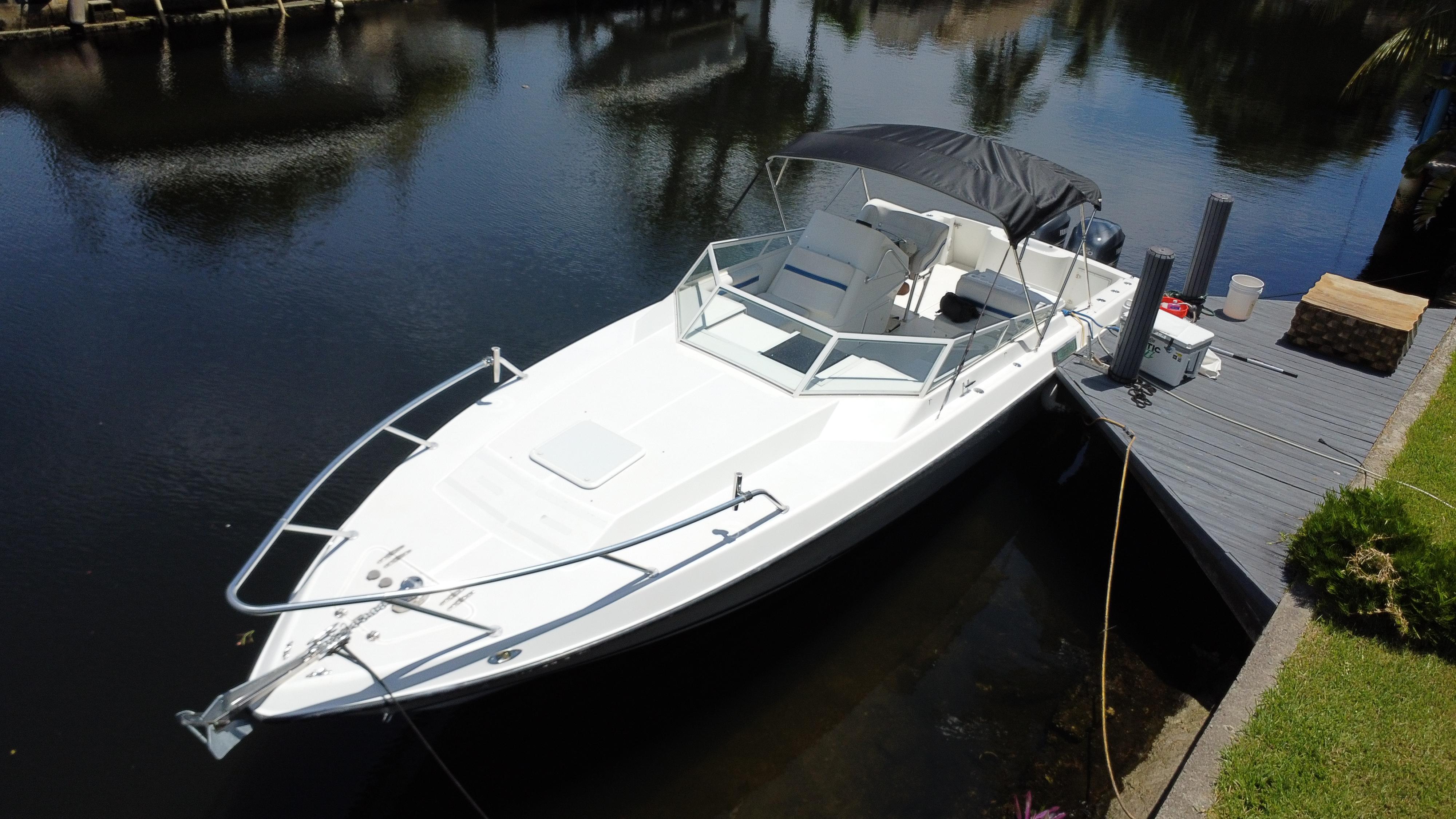 Contender 35 Side Console 2000 Contender 35 Side Console boat docked on calm water, featuring sleek design and canopy.