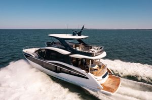 Galeon 620 FLY 2026 Galeon 620 FLY yacht cruising on open sea under clear blue sky.