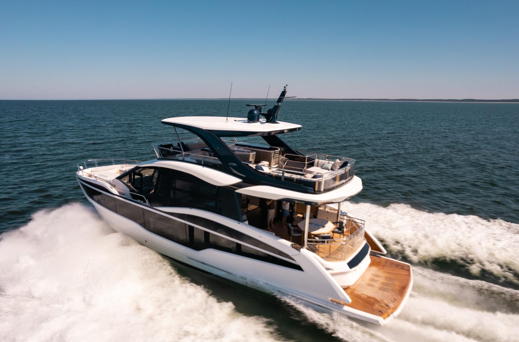 Galeon 620 FLY 2026 Galeon 620 FLY yacht cruising on open sea under clear blue sky.