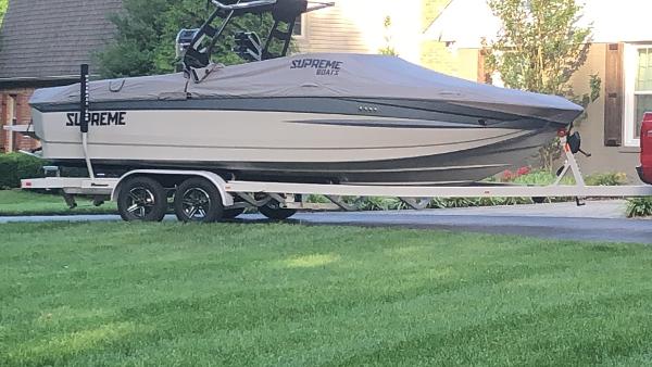 Supreme S240 2022 Supreme S240 boat on trailer in residential driveway.