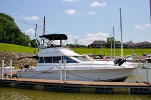 Silverton 37 Convertible 1996 Silverton 37 Convertible yacht docked at marina under clear sky.